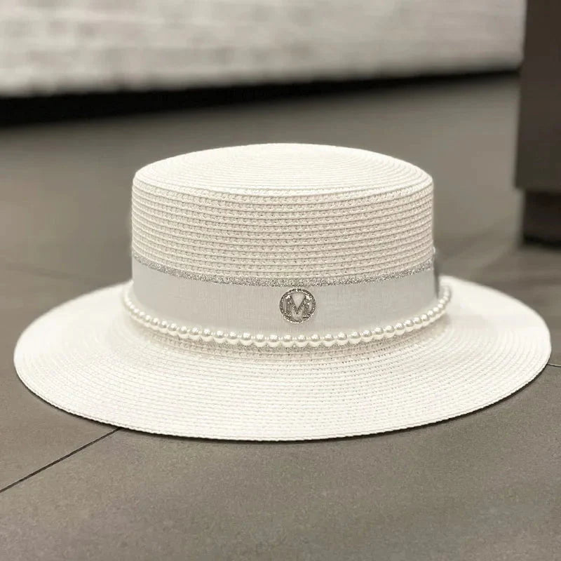 Straw hat with ribbon and pearl