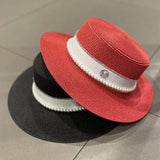 Straw hat with ribbon and pearl