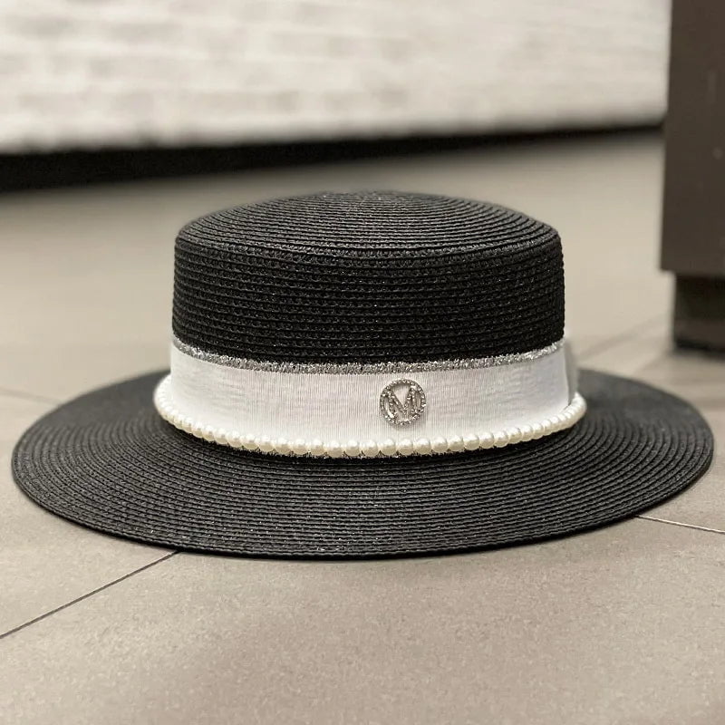 Straw hat with ribbon and pearl